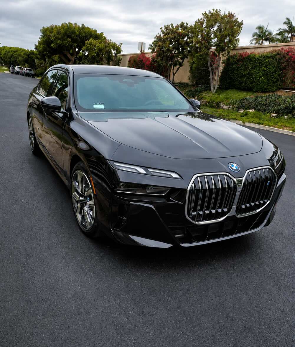 Chauffeur waiting with a luxury SUV for Orange County car service